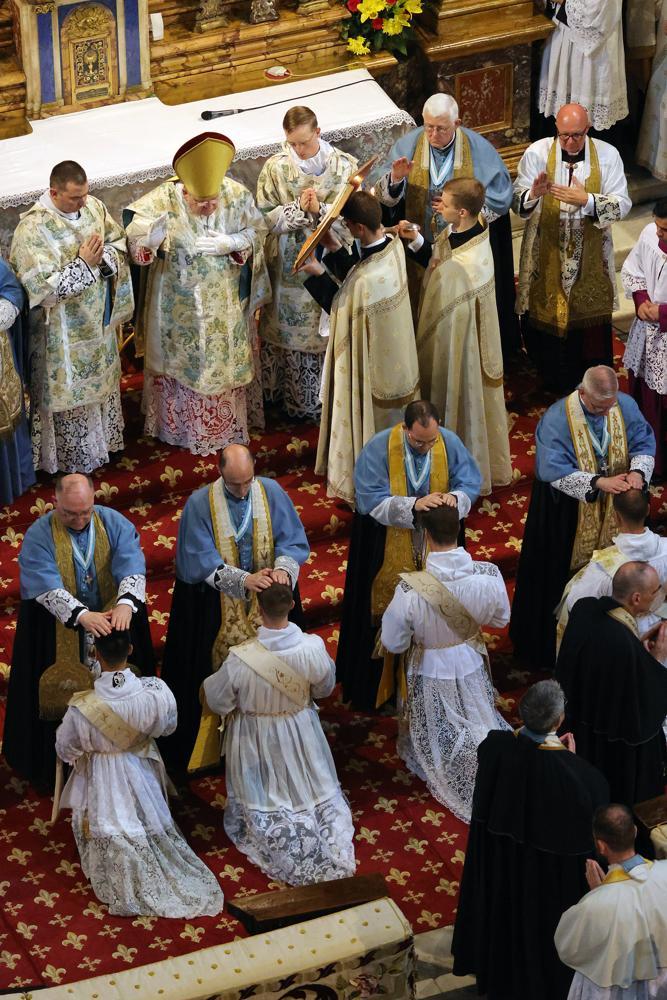 Les prêtres présents imposent les mains aux ordinands
